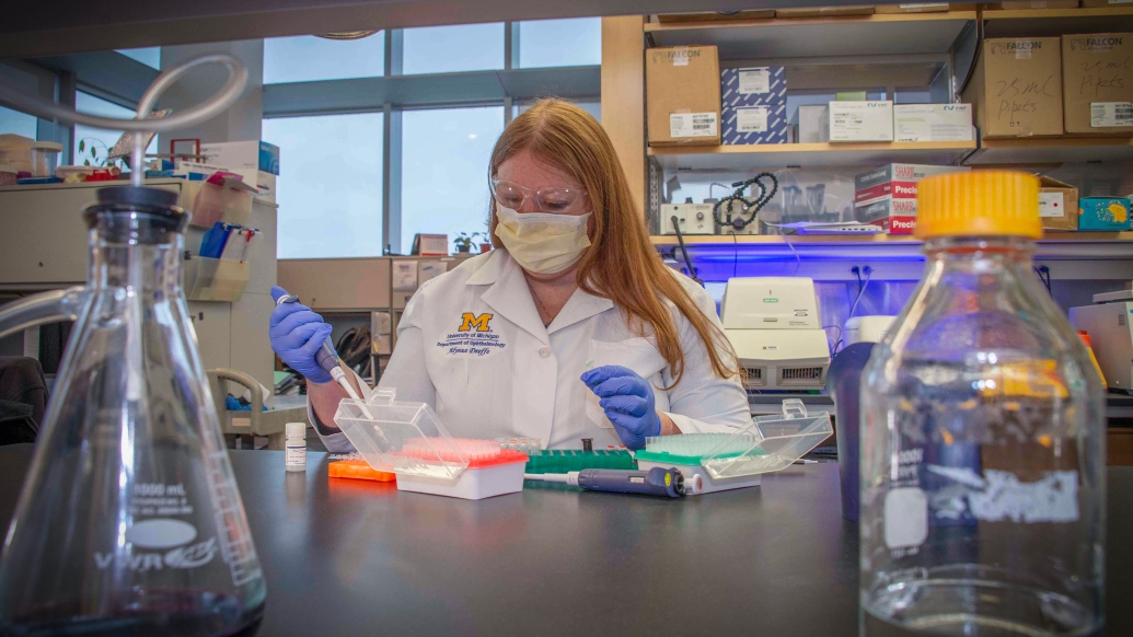 lab bench scientist white coat in lab doing experiment