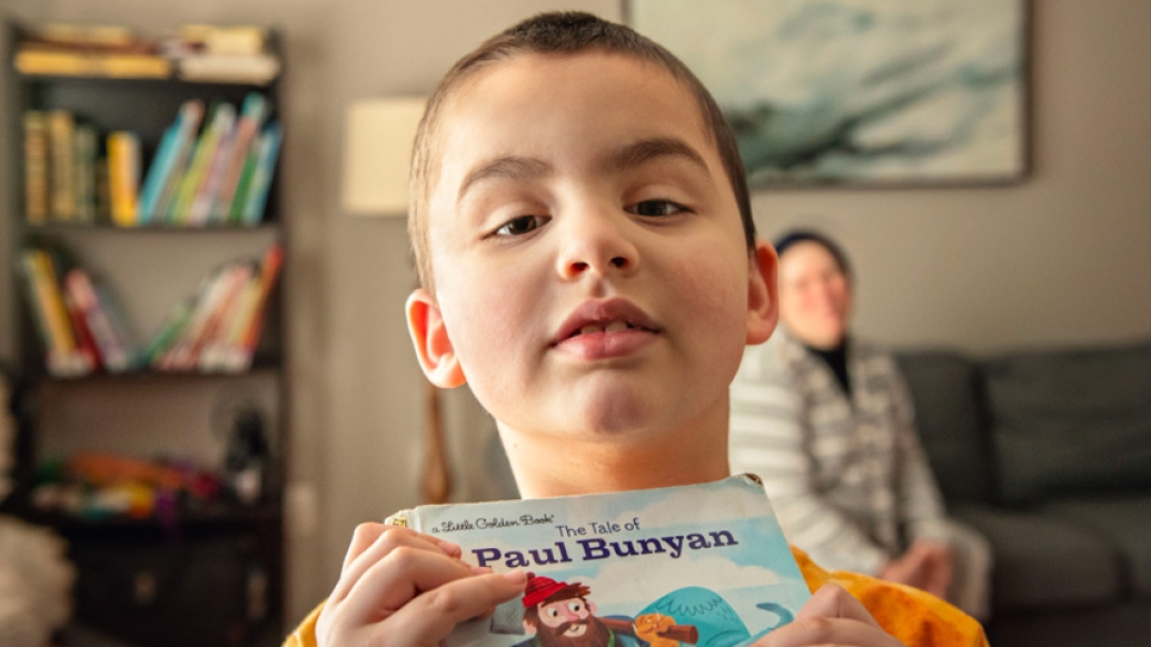 boy holding book 