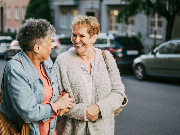 friends talking outside older walking smiling