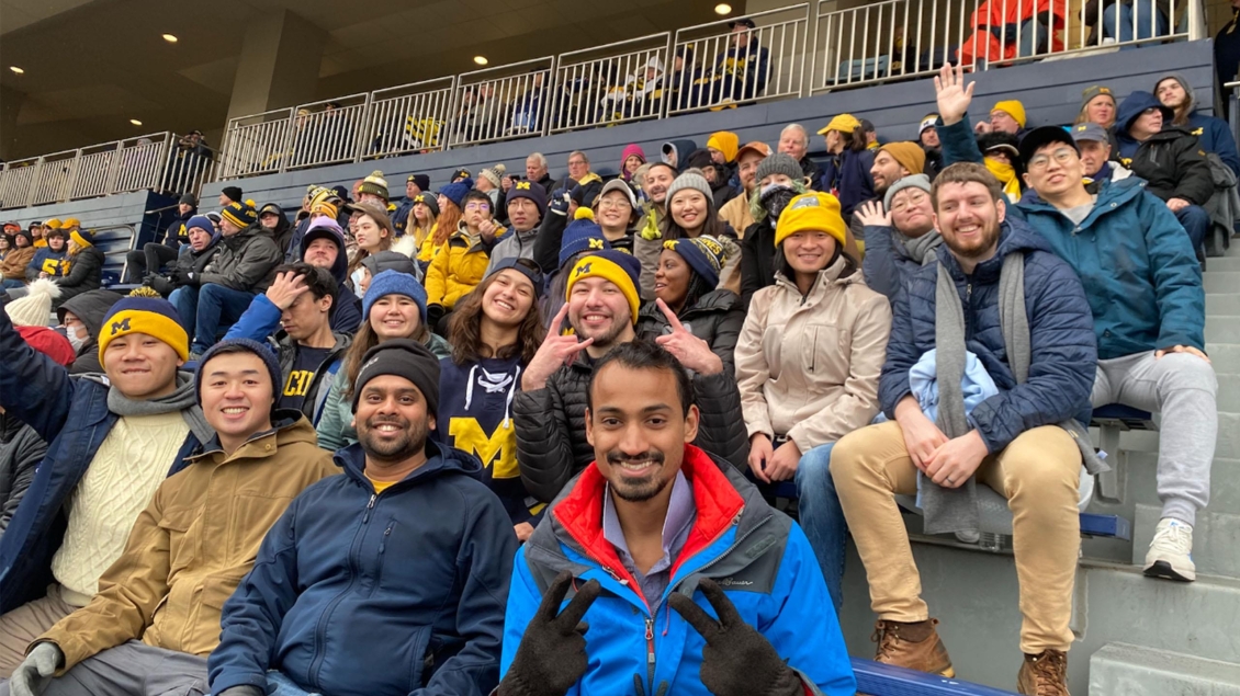 Students enjoy their time at a university of Michigan versus Nebraska football game 