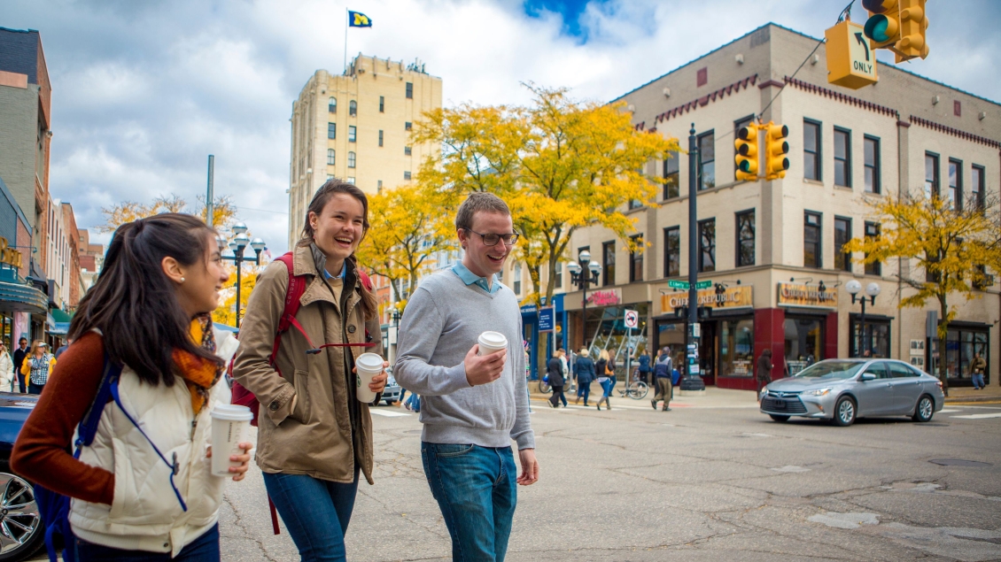 Three people walking in downtown Ann Arbor