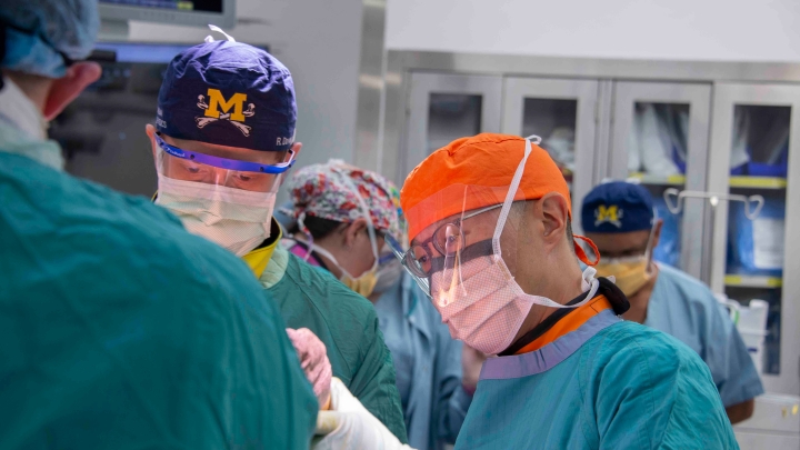 a group of surgeons wearing scrubs and face masks
