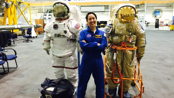 person standing with two space suits