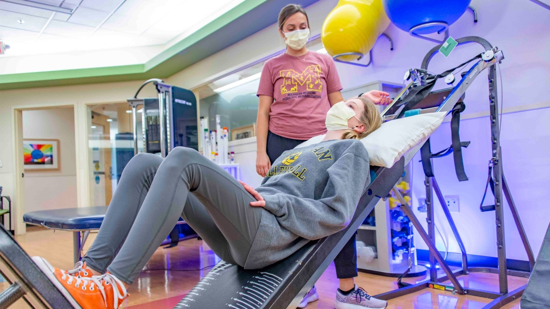 physical therapy girl in gym with trainer