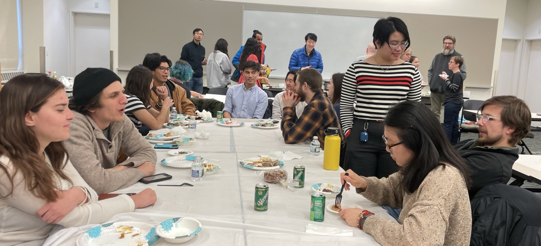 Students gather at a table to enjoy pie on Pi Day