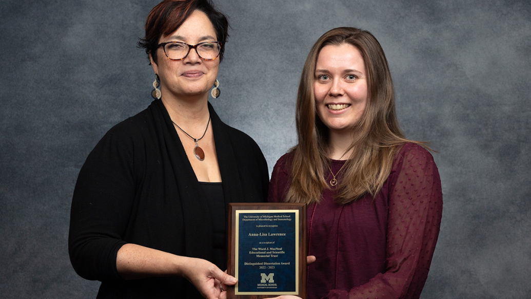 Professor Mary O'Riordan (left) and Dr. Anna-Lisa Lawrence hold the MacNeal Award plaque