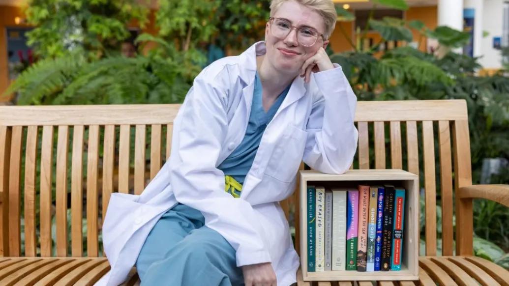 Chelsea Fisk sitting on a bench outside