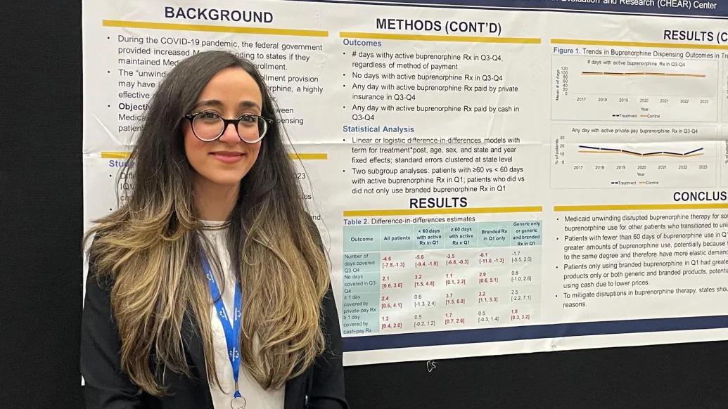 Joanne standing in front of a research poster she created