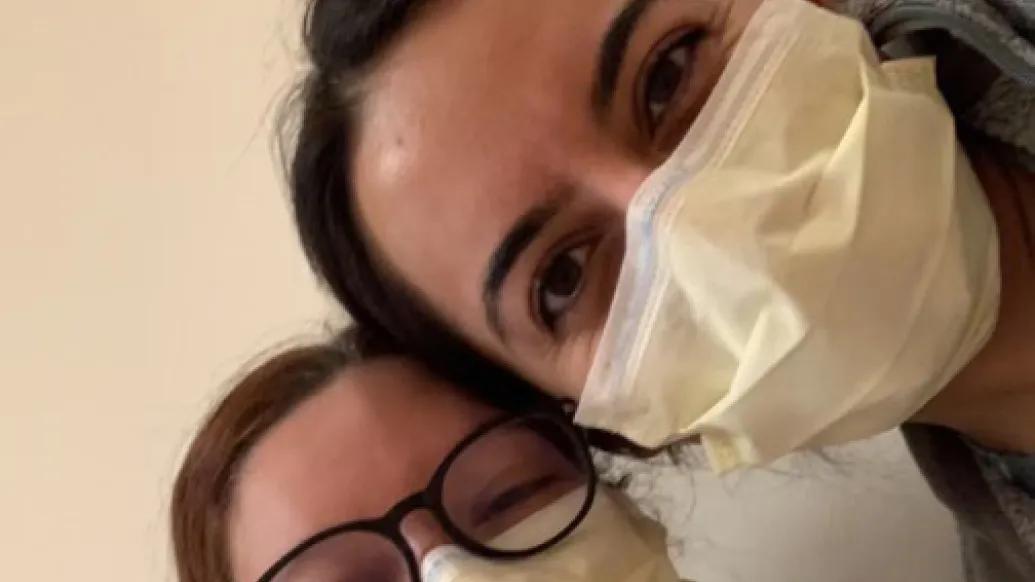 Two medical students in masks take a selfie