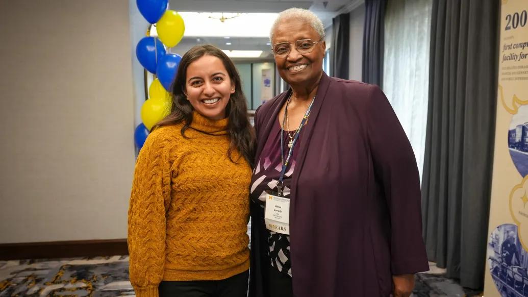 woman posing with woman smiling
