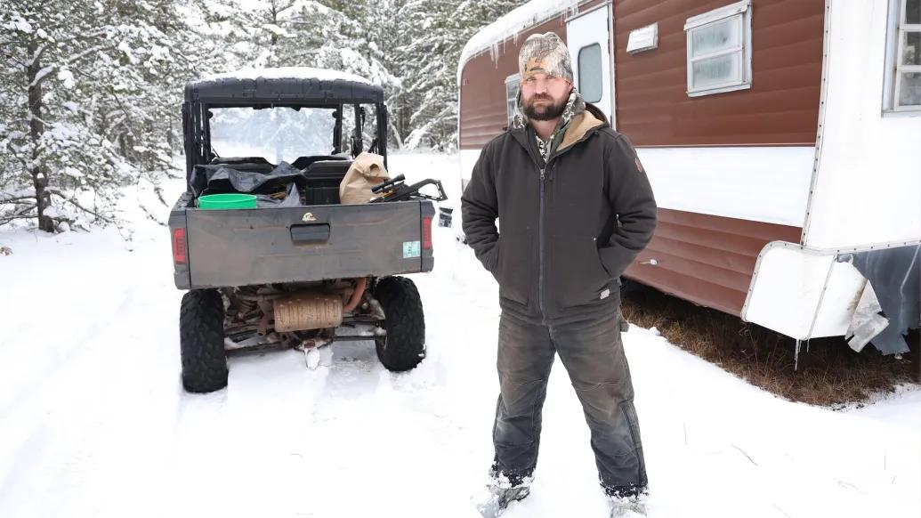man standing outside in snow looking at camera 
