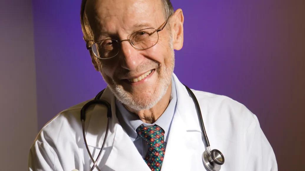 Thomas D. Gelehrter, MD, in white coat