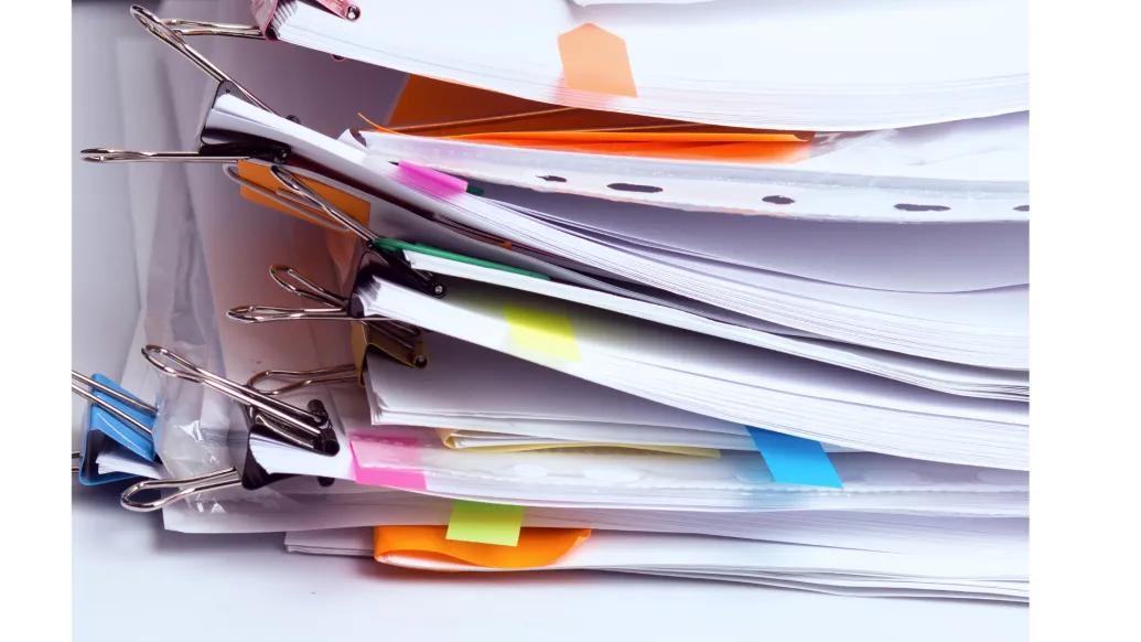 a large stack of messy papers