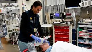 Medical professional helping patient breathe in hospital