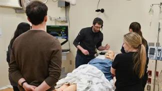 Medical trainees listening to instructor