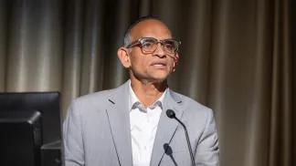 Prashant Mahajan, MD, MPH, MBA standing at podium