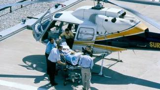 Survival flight team with gurney and helicopter