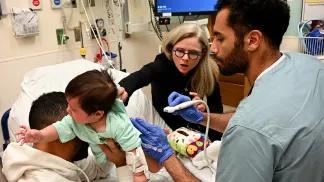 Tech using a handheld ultrasound wand on a patient