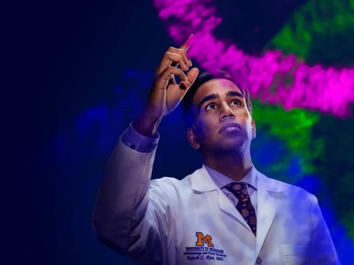 Dr. Rajesh Rao using his finger to create a pink line of 