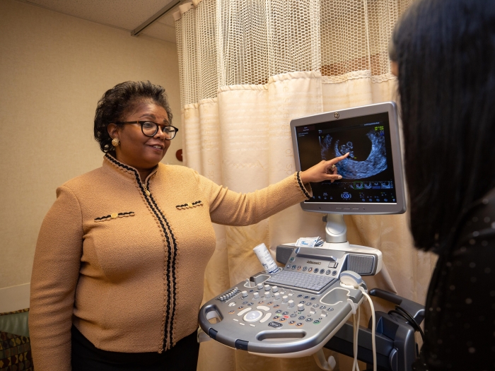  doctor shows patient ultrasound scans on screen 