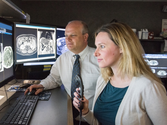 doctor and resident reading radiology scans 