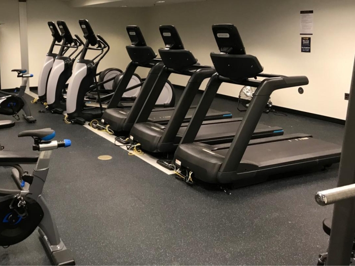 med school fitness center with row of treadmills 