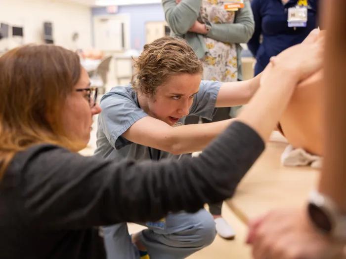 Teacher assisting student during simulation delivery