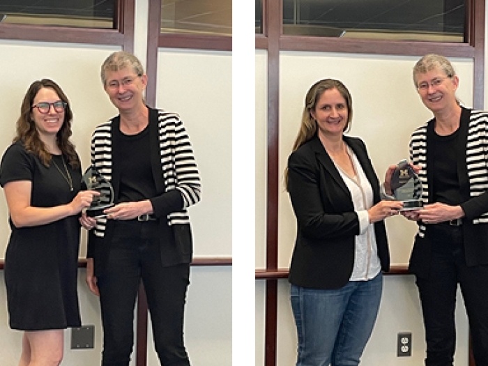 Brittany Bowman, PhD, and Stefanie Galban, PhD pose for a photo with their awards