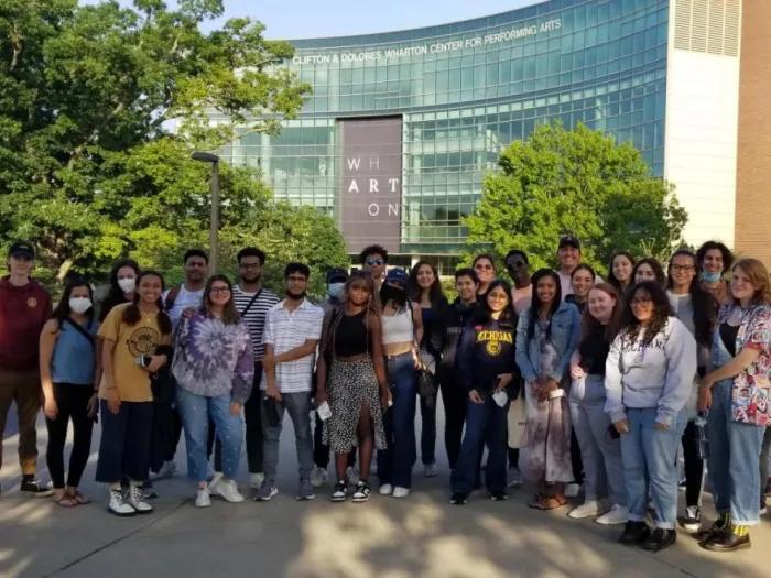 A large group of NURO students pose for a photo outside