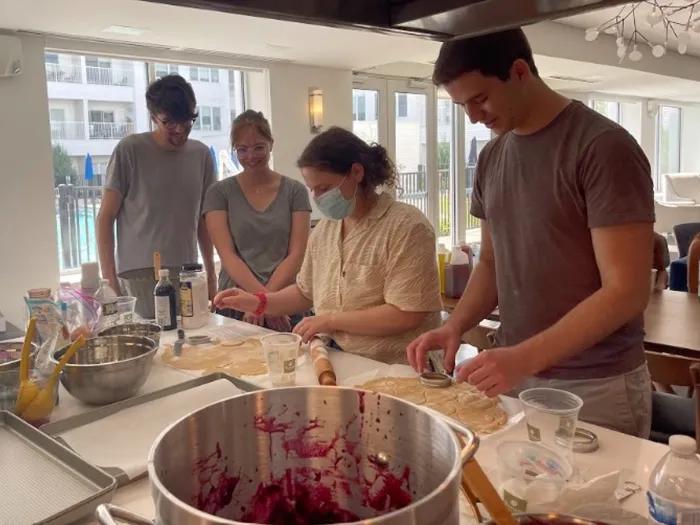 People working at a table cooking