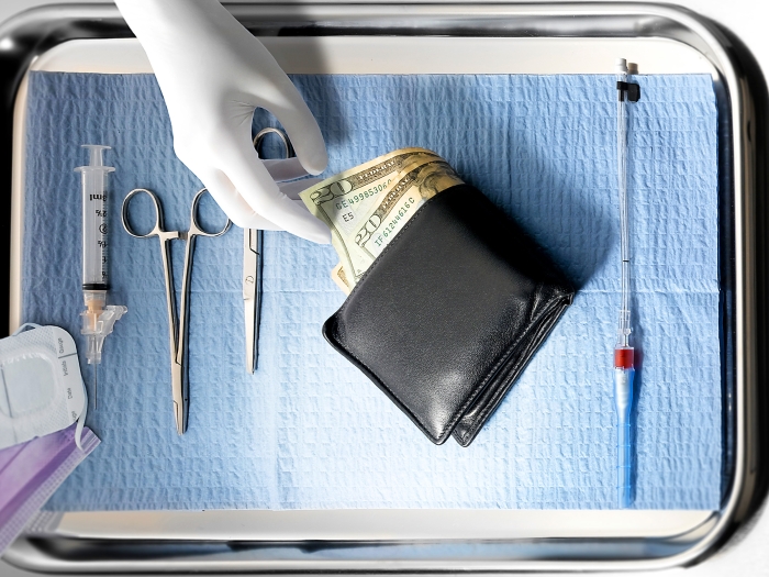 Surgeon's tray with gloved hand reaching into wallet