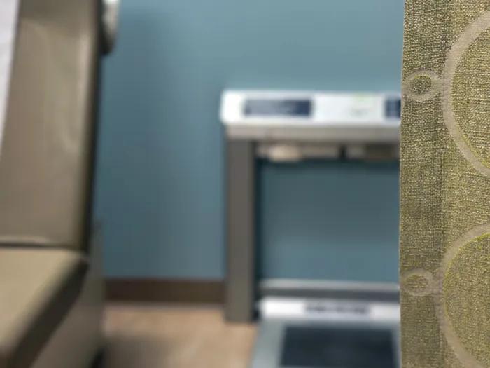 Scale pictured behind a hospital room curtain