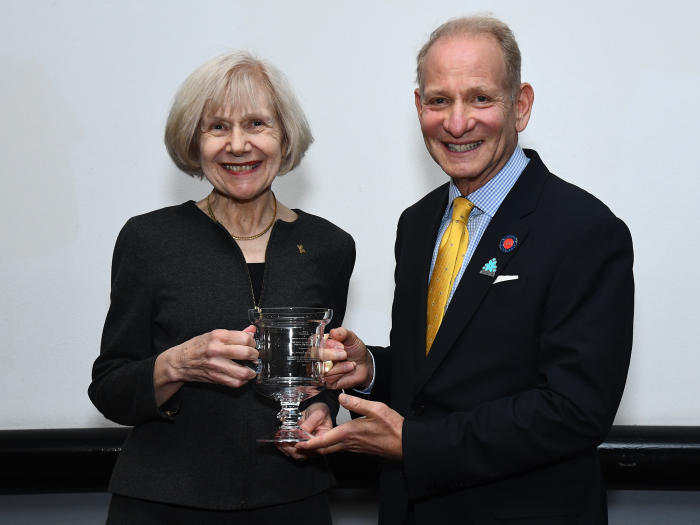 a photo of Dr. Eva Feldman receiving the Sheila Essey Award with James Essey