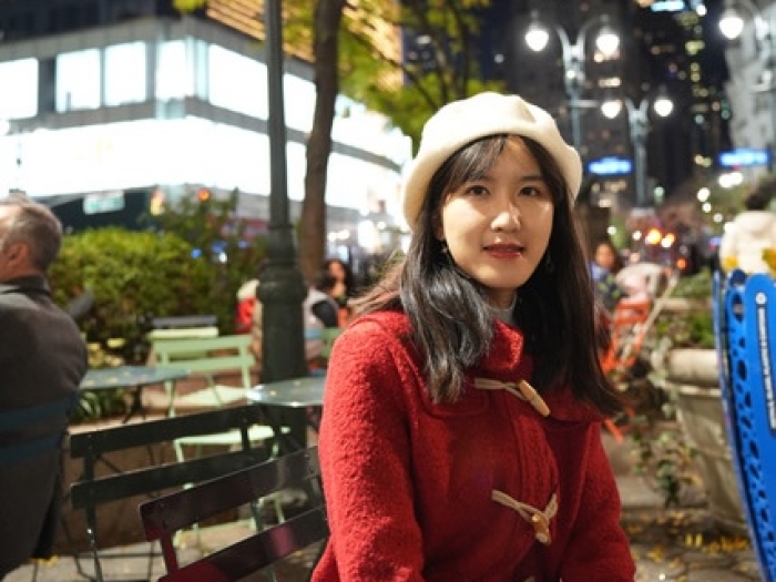 Wenjin Gu sitting outside at a cafe table