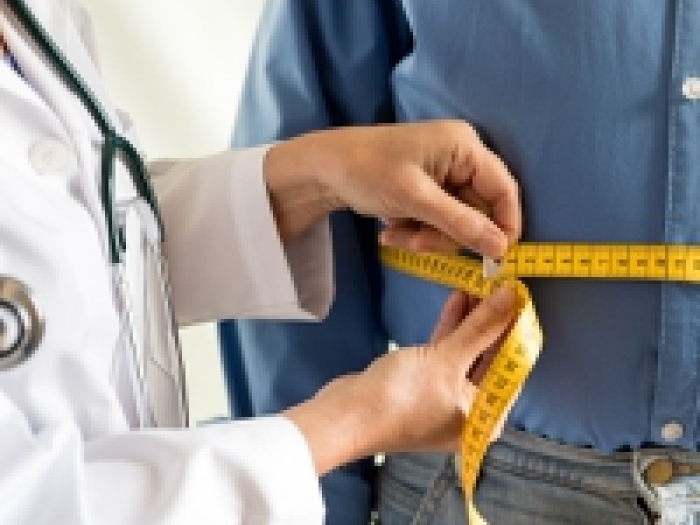 doctor measuring waistline