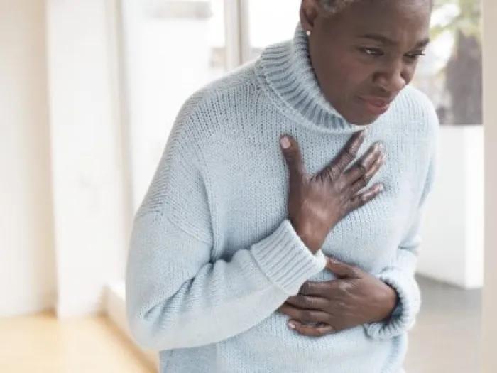Older woman clutching her chest in pain