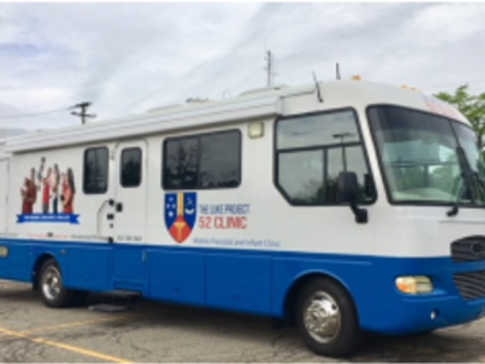 A blue and white van that serves as a mobile clinic