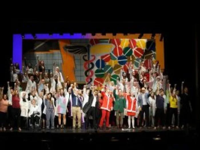 A huge group of people performing on a stage