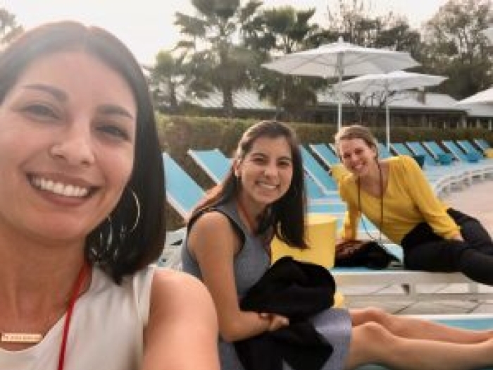 A selfie of three women at the poolside 