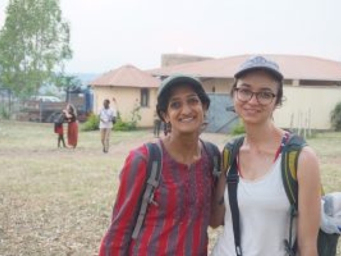 Two people with a village in the background