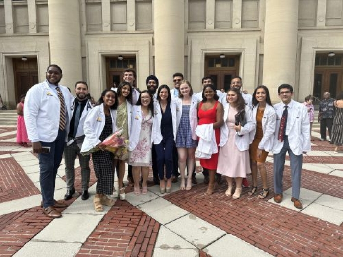 Group of people in white coats standing for a photo