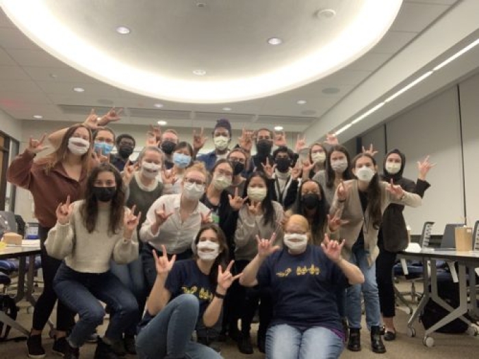 A group of people in face masks posing for the camera