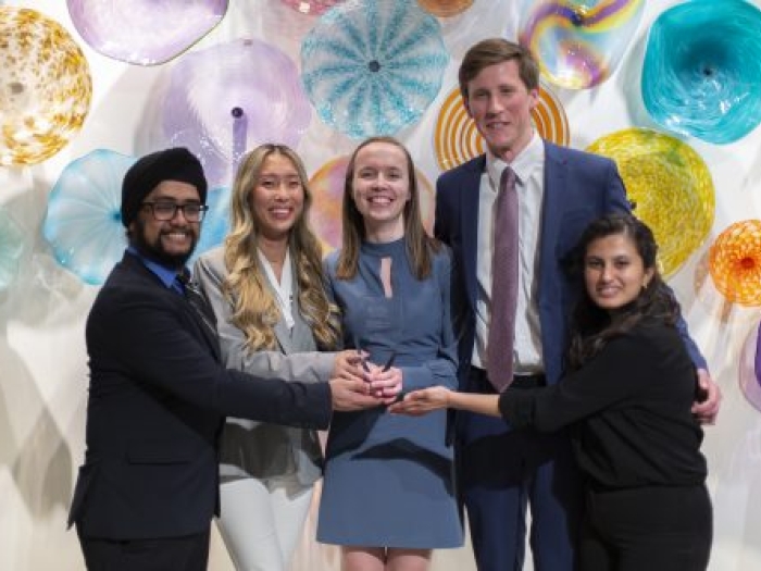 Five people standing together for a photo