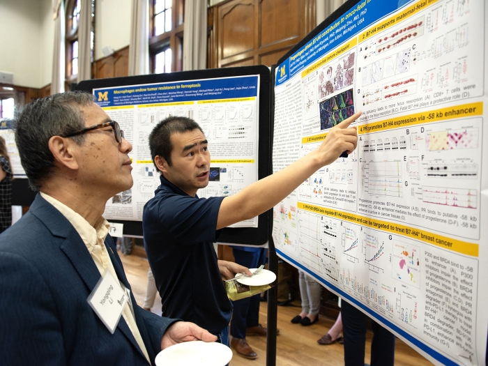 Two people looking at a poster presentation