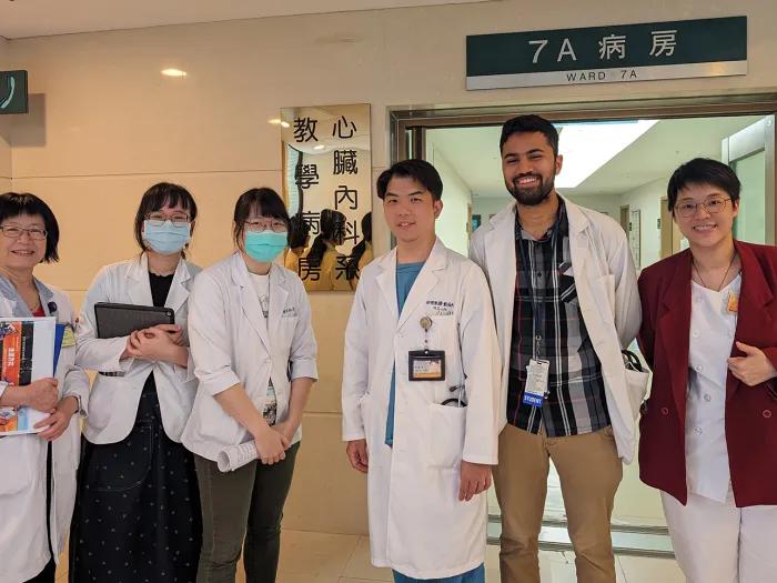 Group of doctors wearing white doctors coats, posing for a photo