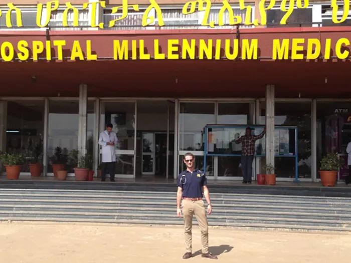 A person standing in front of St. Paul's hospital in Ethiopia