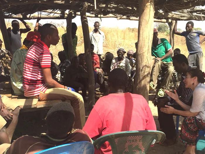 A group of people speaking together in Ghana