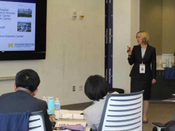 A lecturer giving a talk to an audience