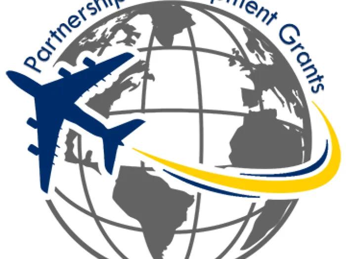 Graphic of a globe with a navy blue plane flying around it, with the words 'Partnership Development Grants' written along the circumference of the globe