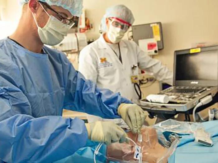 Two doctors working in an emergency room.